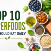 Top 10 superfoods including salmon, avocado, blueberries, spinach, oats, nuts, and green tea arranged on a healthy food background