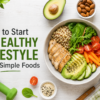 Healthy lifestyle feature image with simple foods including avocado, vegetables, chicken, quinoa, nuts, and healthy meal ingredients on a white table